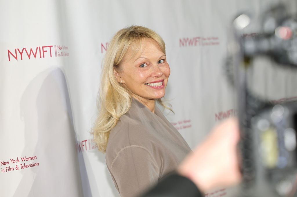 photo of pamela anderson smiling at red carpet event