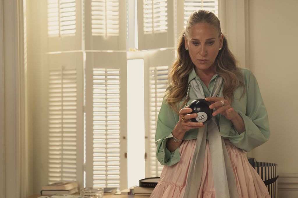 Carrie Bradshaw green blouse and pink skirt on And Just Like That...