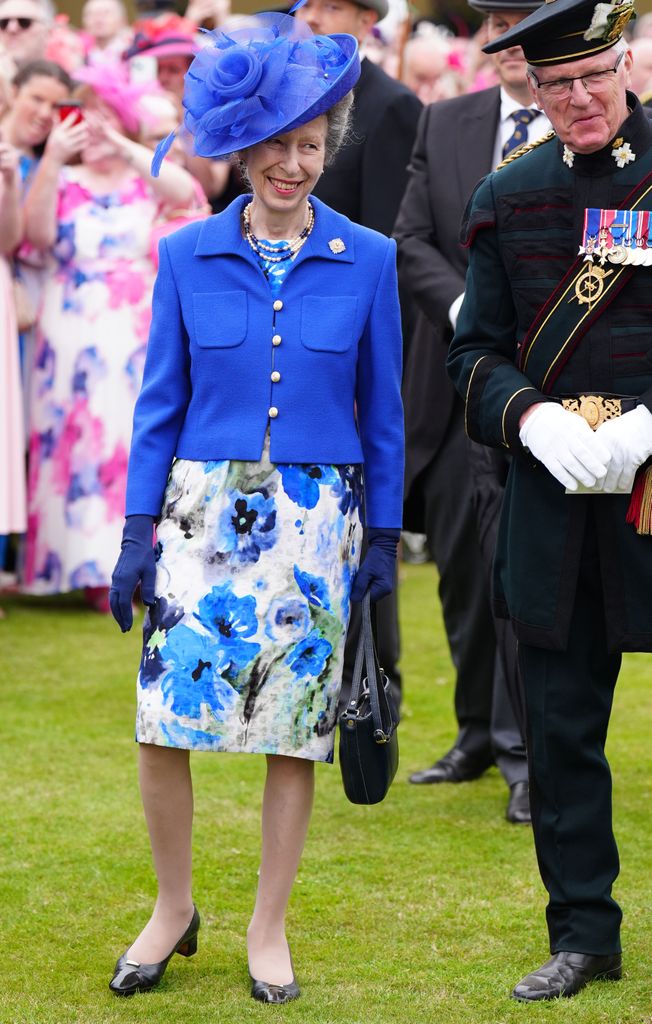 Princess Anne wearing blue jacket and floral dress